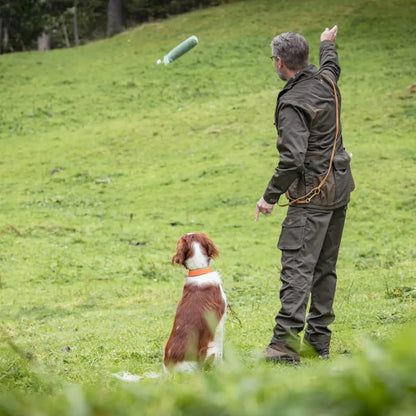 Person playing fetch with a dog in a field while wearing Deerhunter Rogaland Trousers