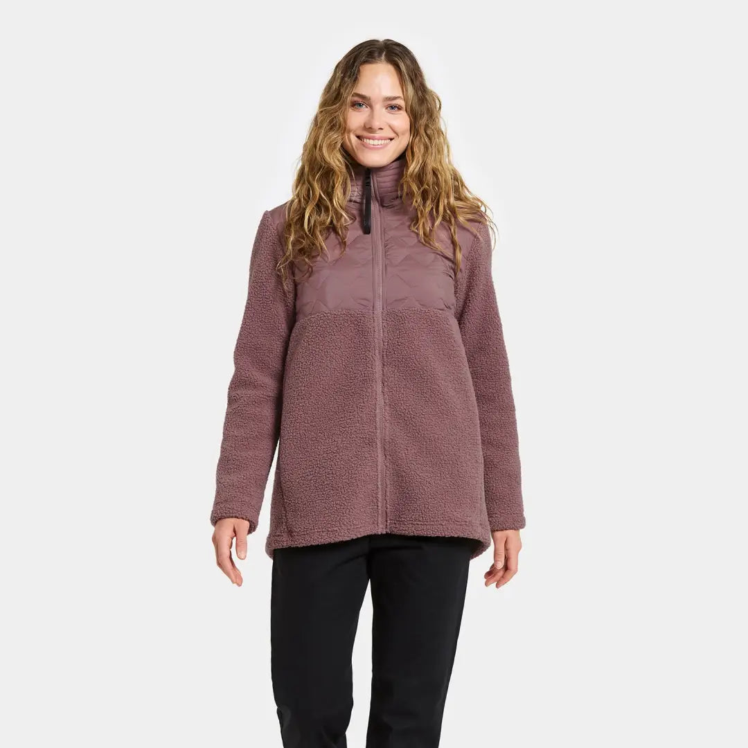 Woman in purple sherpa fleece jacket and black pants, perfect for country clothing outdoors