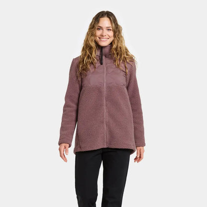 Woman in purple sherpa fleece jacket and black pants, perfect for country clothing outdoors