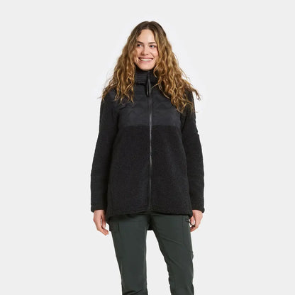 Woman wearing Didriksons Bibi 2 fleece jacket with dark green pants for country clothing outdoors