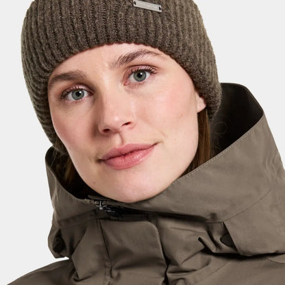 Woman in a ribbed beanie and hooded jacket, perfect for sporty mid-length parka style