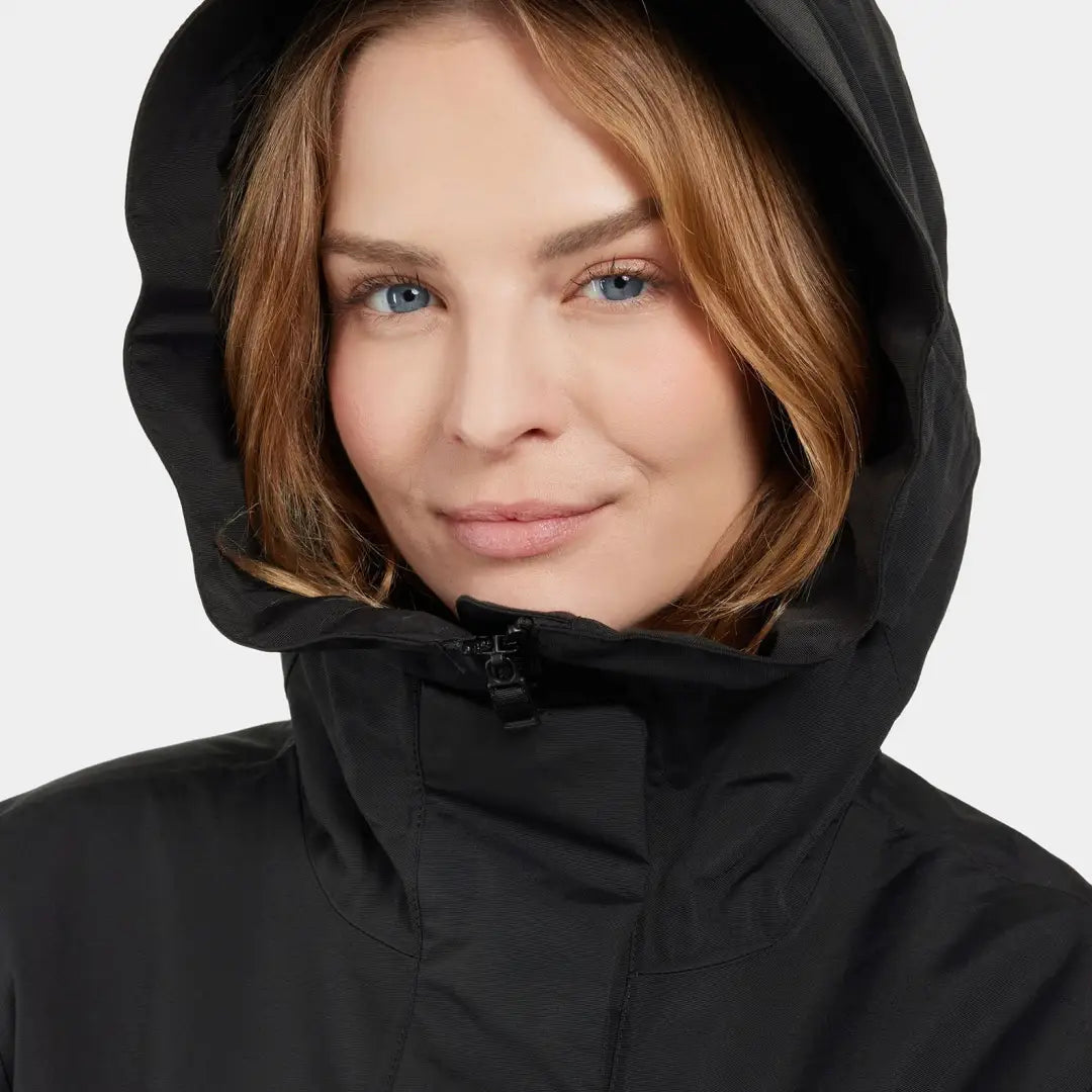 Woman in a black waterproof sporty mid-length parka from Didriksons Frida Womens Parka 7