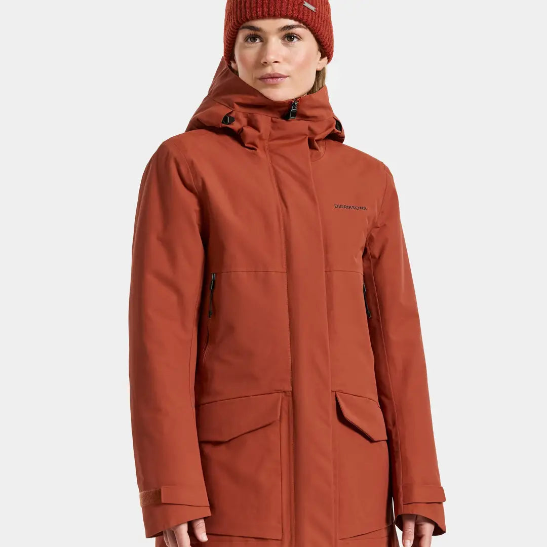 Women’s terracotta-colored sporty mid-length parka with hood for winter warmth