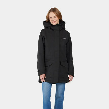 Woman in a black sporty mid-length parka and blue jeans showing Didriksons Frida Womens Parka 7