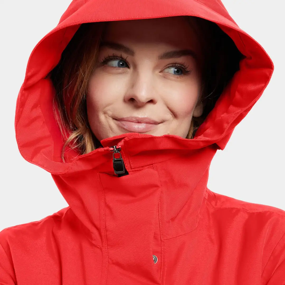 Woman in a red sporty mid-length parka with high collar, Didriksons Frida Womens Parka