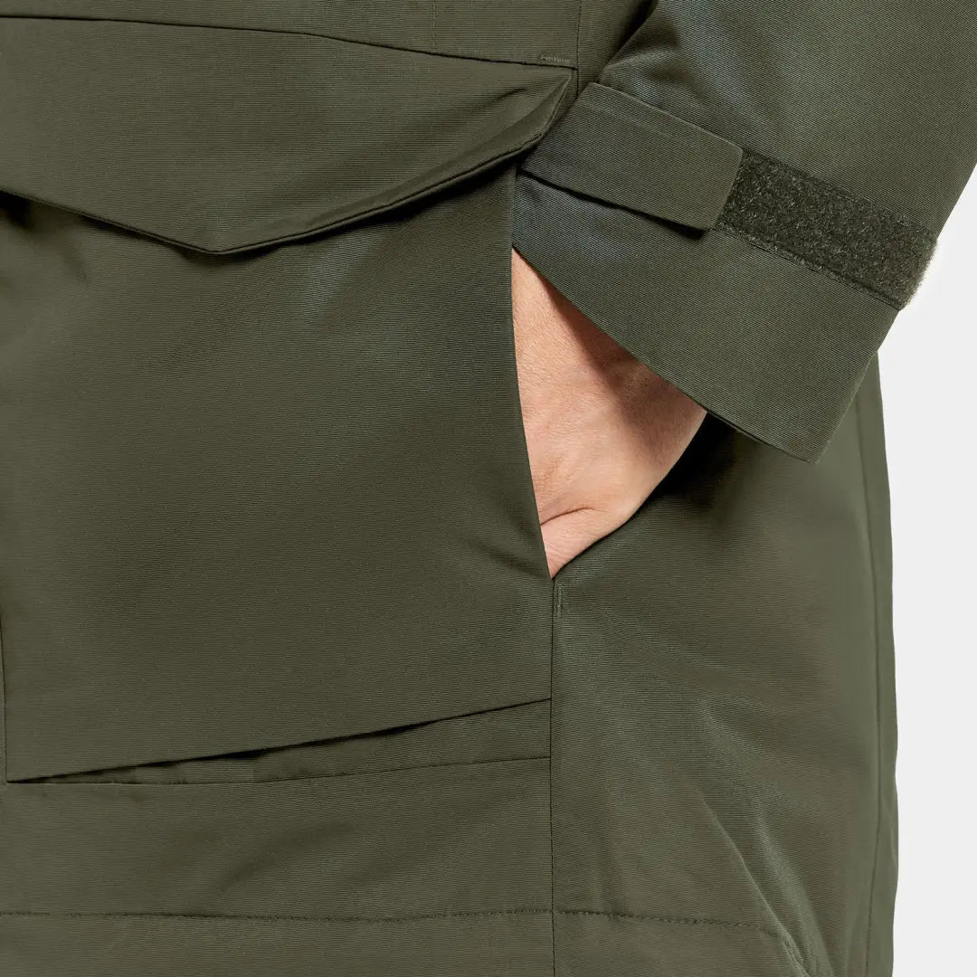 Close-up of a hand in a dark olive green Didriksons Frida Womens Parka mid-length sporty jacket