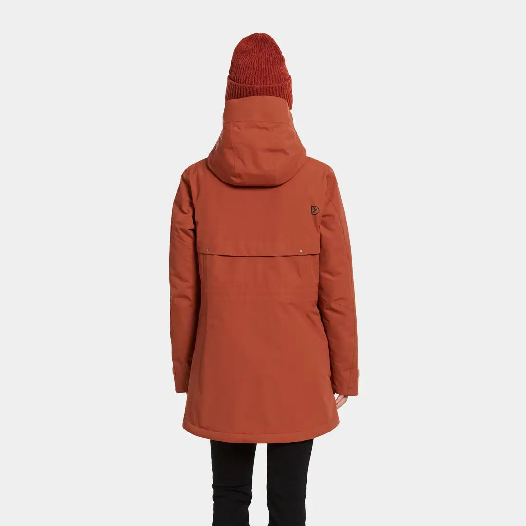 Burnt orange sporty mid-length parka with hood and brown beanie for winter warmth