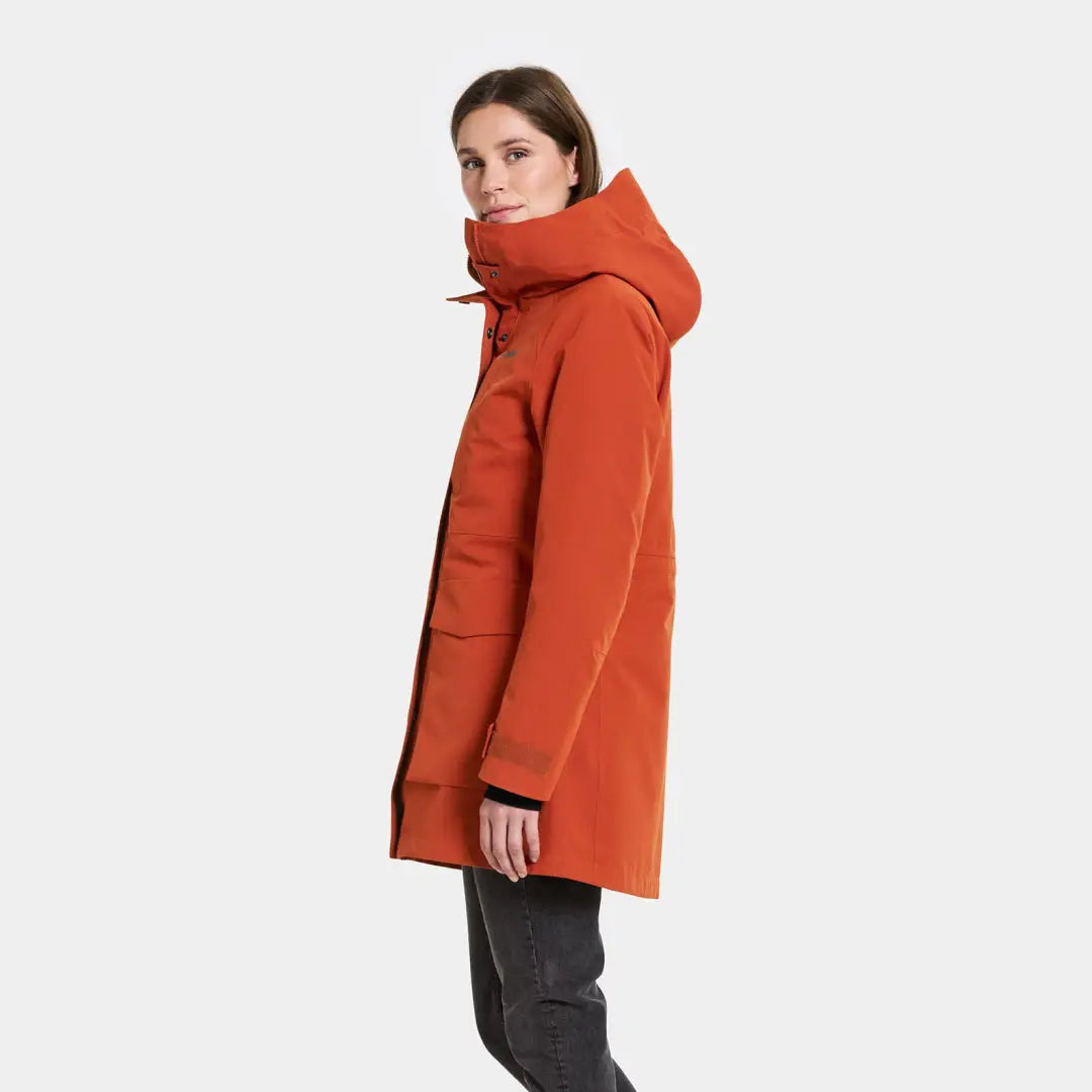 Woman modeling Didriksons Harriet waterproof parka with hood and large pockets for country clothing or hunting