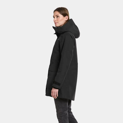 Woman wearing Didriksons Harriet black insulated parka with hood, perfect country clothing for hunting