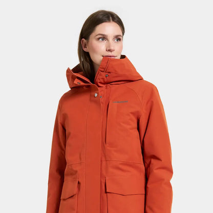 Woman in orange Didriksons Harriet waterproof parka, perfect country clothing for hunting