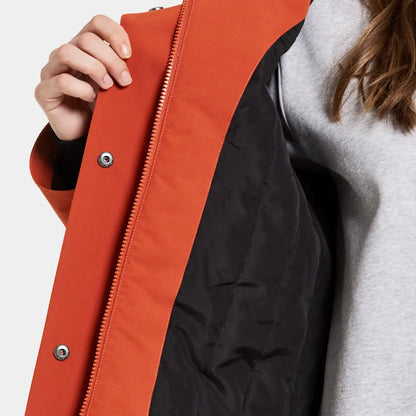 Close-up of Didriksons Harriet womens parka with unzipped orange rain jacket and grey sweatshirt