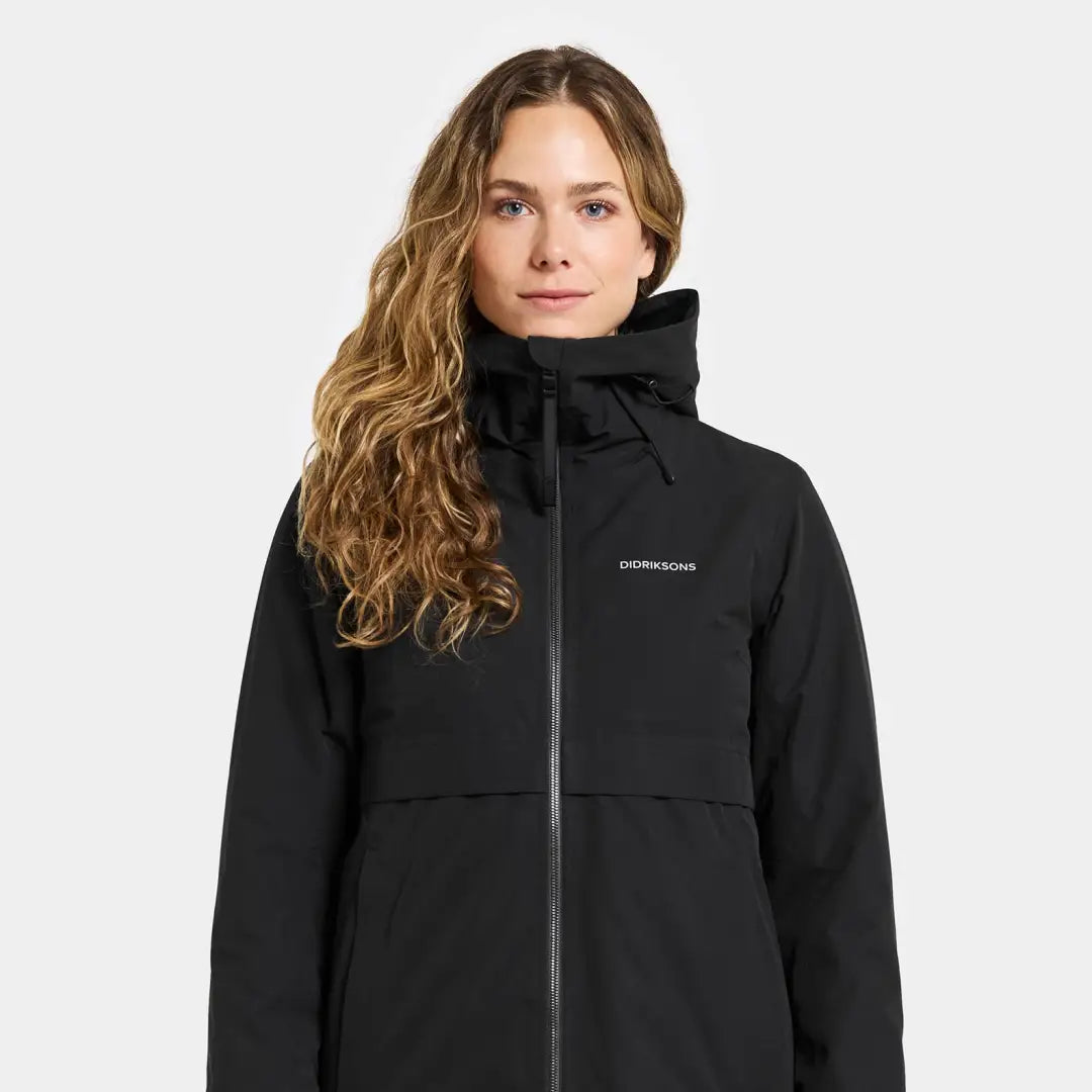 Woman in black waterproof jacket with hood, perfect for country clothing and outdoors adventures