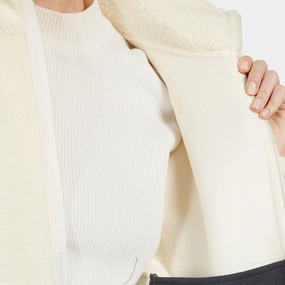 Cream ribbed long-sleeve top with shearling coat, perfect for chilly autumn winds