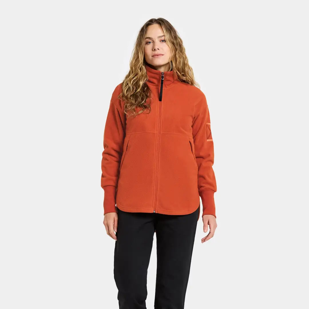 Woman in orange Didriksons Ronja fleece jacket for country clothing and outdoor adventures