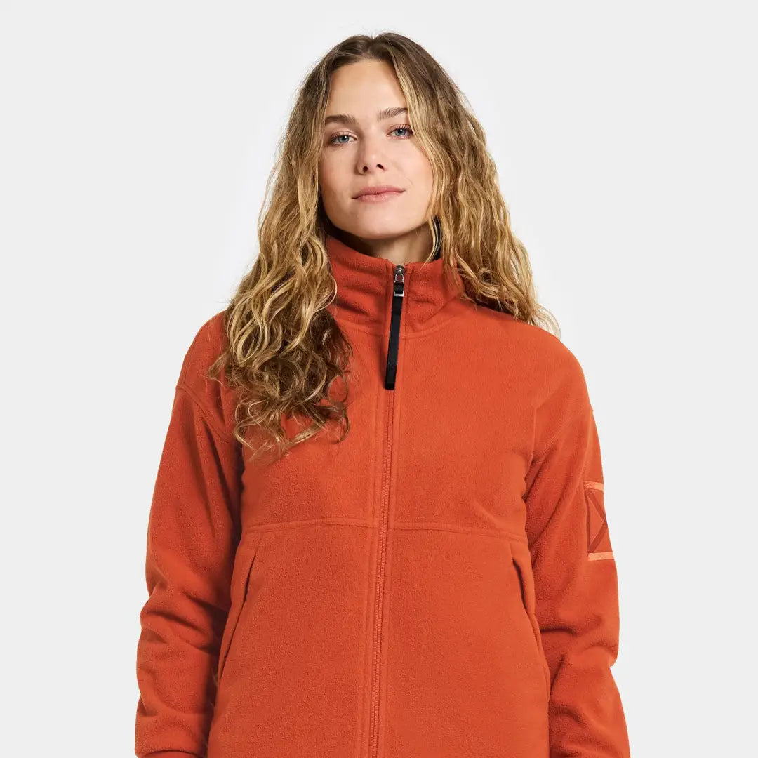 Woman in orange Didriksons Ronja fleece jacket for outdoors and country clothing
