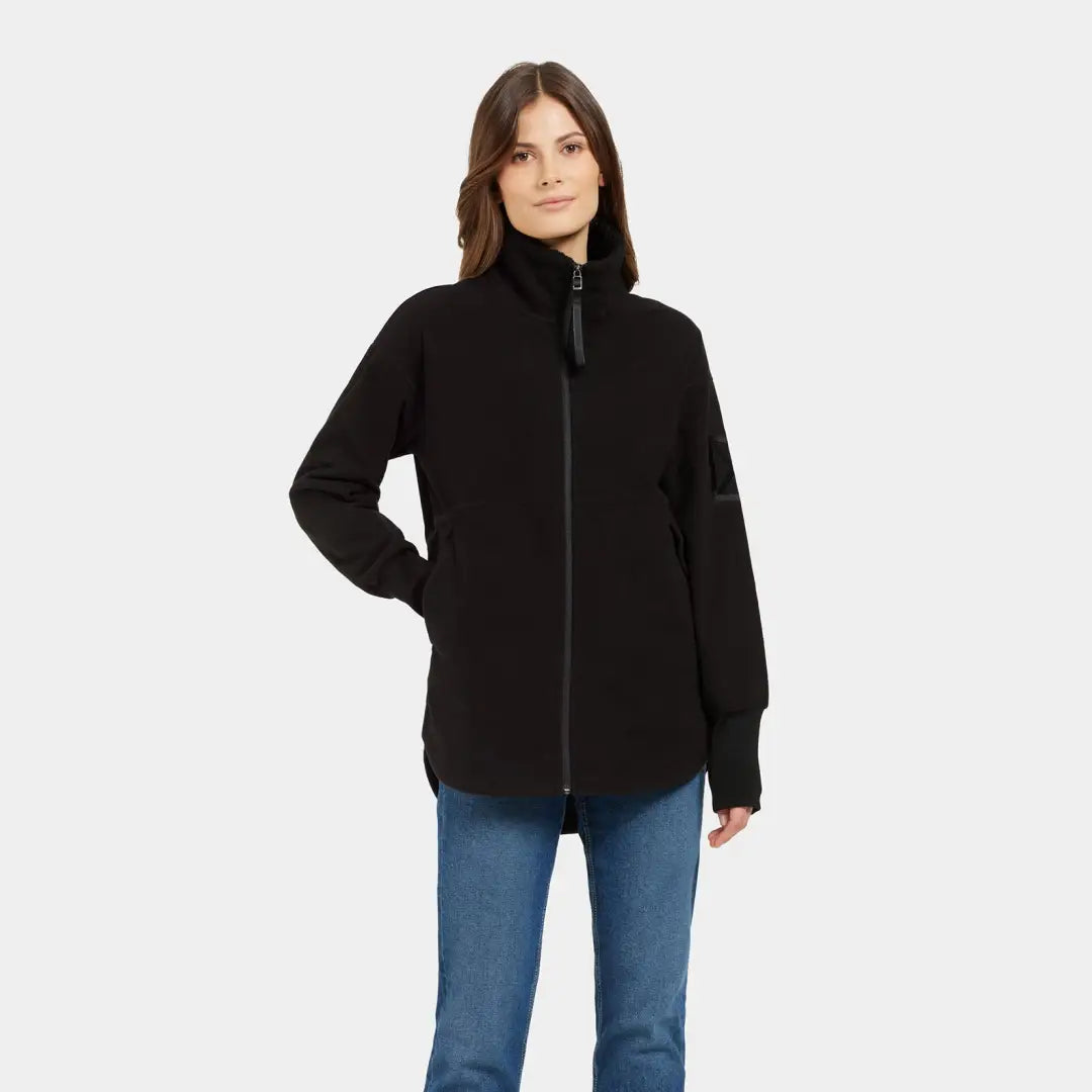 Woman in black full-zip fleece and blue jeans, perfect for country clothing outdoors