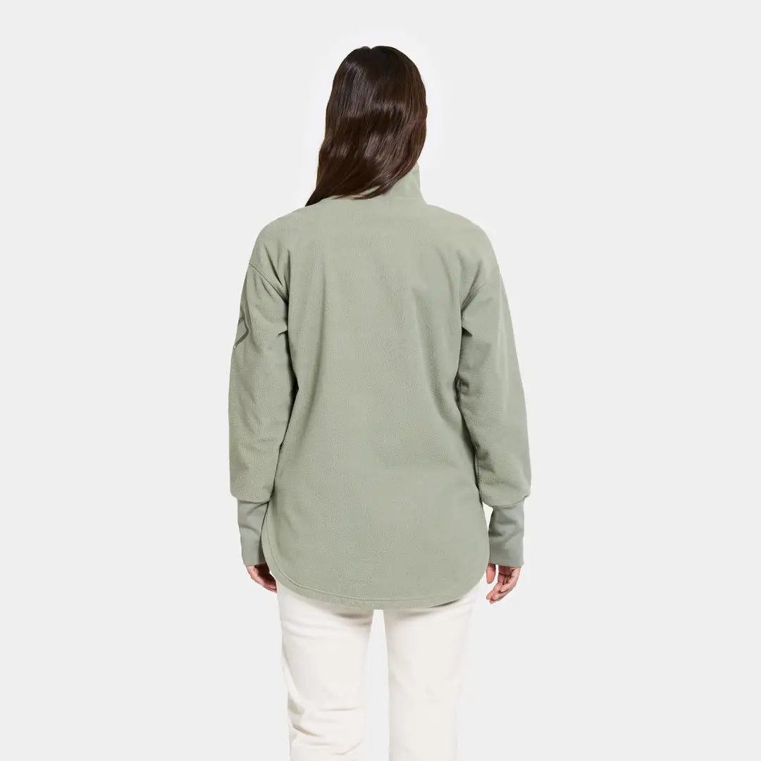 Woman from behind in light green jacket outdoors country clothing for hunting or casual wear