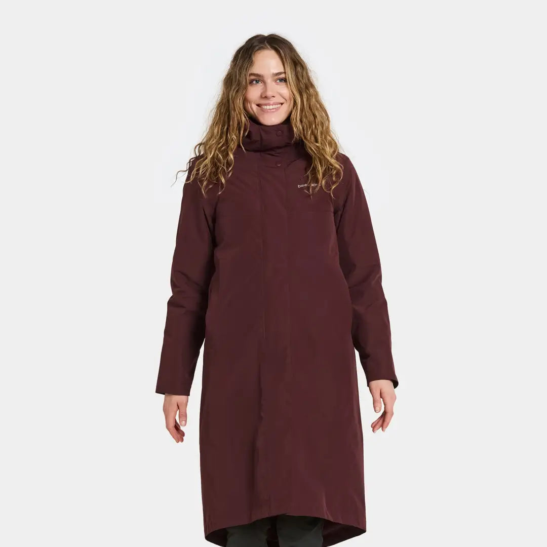 Woman in dark red turtleneck coat from Didriksons Selina Womens Parka, perfect for outdoors and country clothing