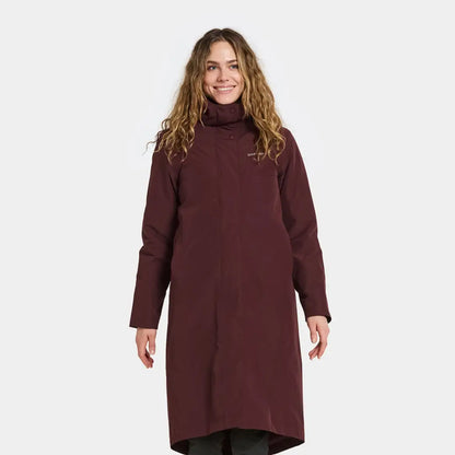 Woman in dark red turtleneck coat from Didriksons Selina Womens Parka, perfect for outdoors and country clothing