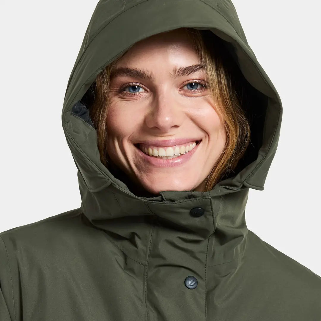 Smiling woman in Didriksons Selina Womens Parka, perfect for country clothing outdoors