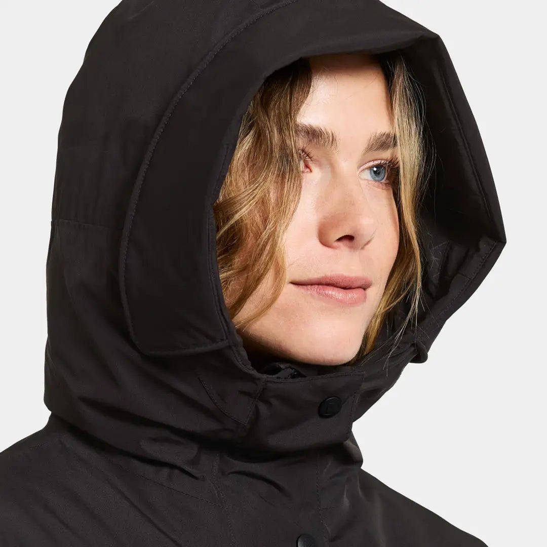 Woman in black hooded jacket from Didriksons Selina Womens Parka, perfect for outdoors and country clothing