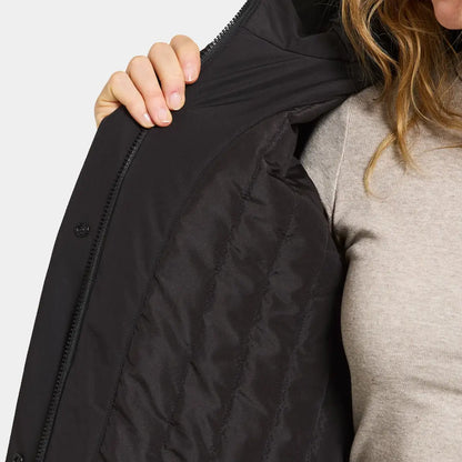Woman in black quilted jacket with beige shirt, perfect country clothing for outdoors