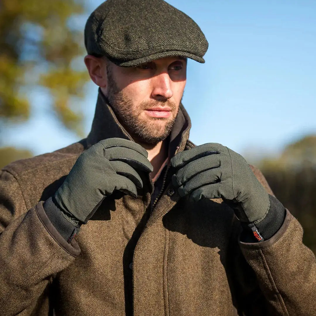Man in tweed attire wearing Extremities Sportsman Gloves for outdoor adventures