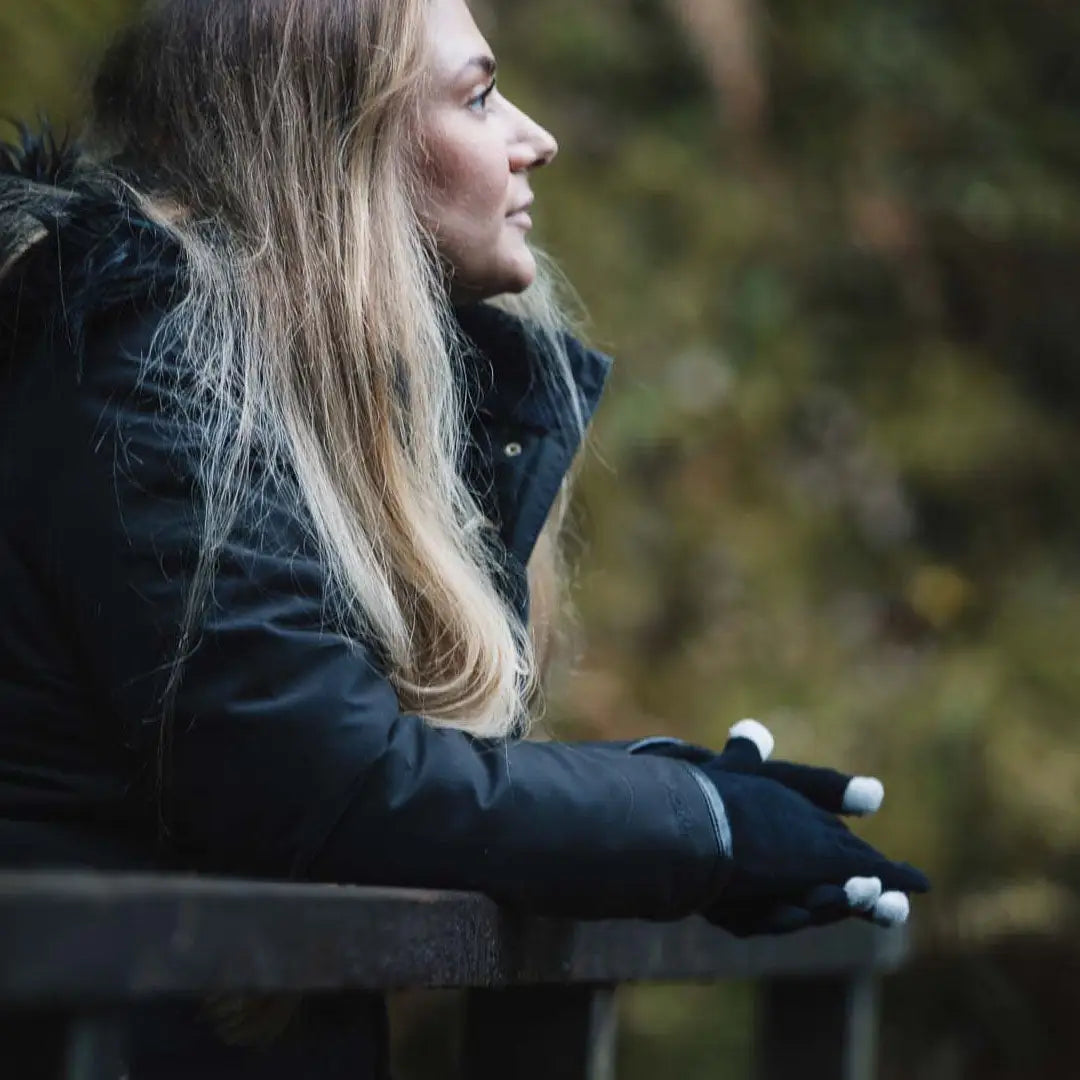 Woman in winter coat wears Extremities Thinny Touch Gloves for cold weather comfort