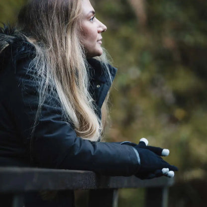 Woman in winter coat wears Extremities Thinny Touch Gloves for cold weather comfort