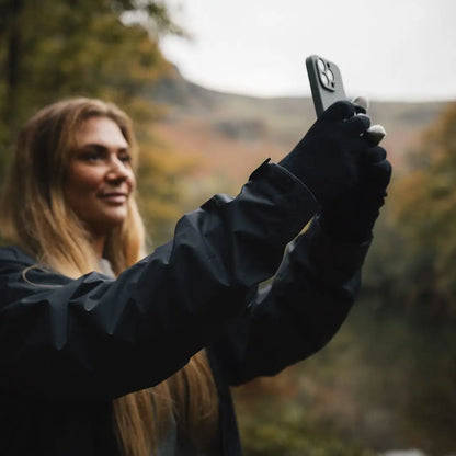 Woman using extremities thinny touch gloves to take a photo with her smartphone