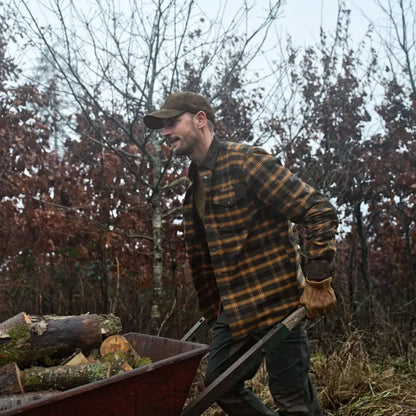 Man pushing logs in Härkila Aivak Long Sleeve Shirt, perfect country clothing for hunting