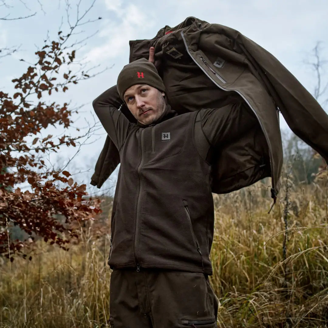 Man carrying Härkila Aspire Fleece Waistcoat showcasing durable fleece waistcoat style