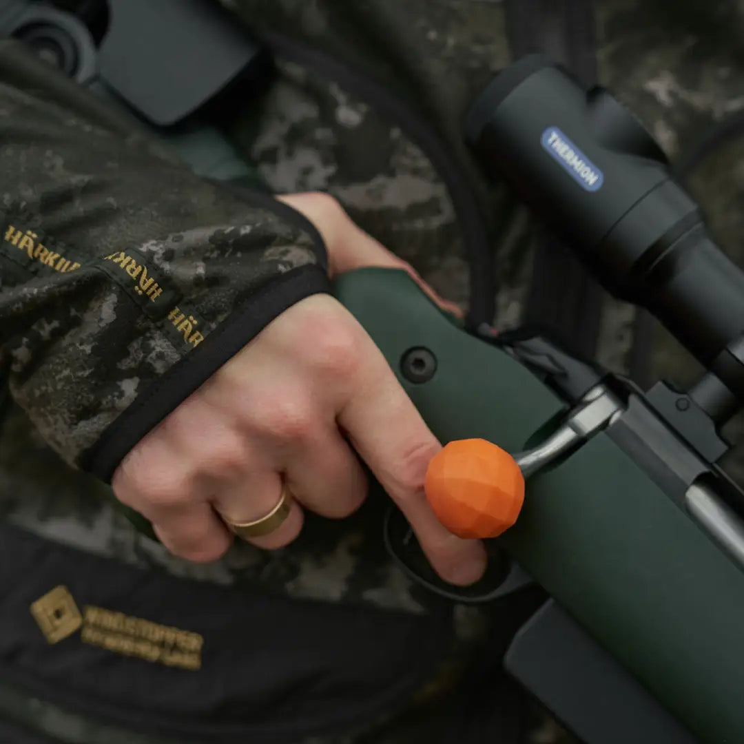 Green rifle with orange bolt knob on Kamko Noctyx WSP Reversible Fleece Jacket
