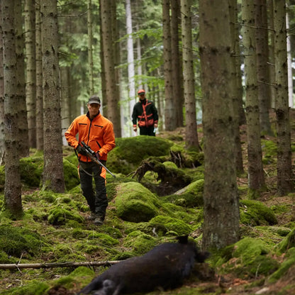 Hunters with rifle and dead boar in Härkila Kamko Reversible Fleece Jacket for hunting