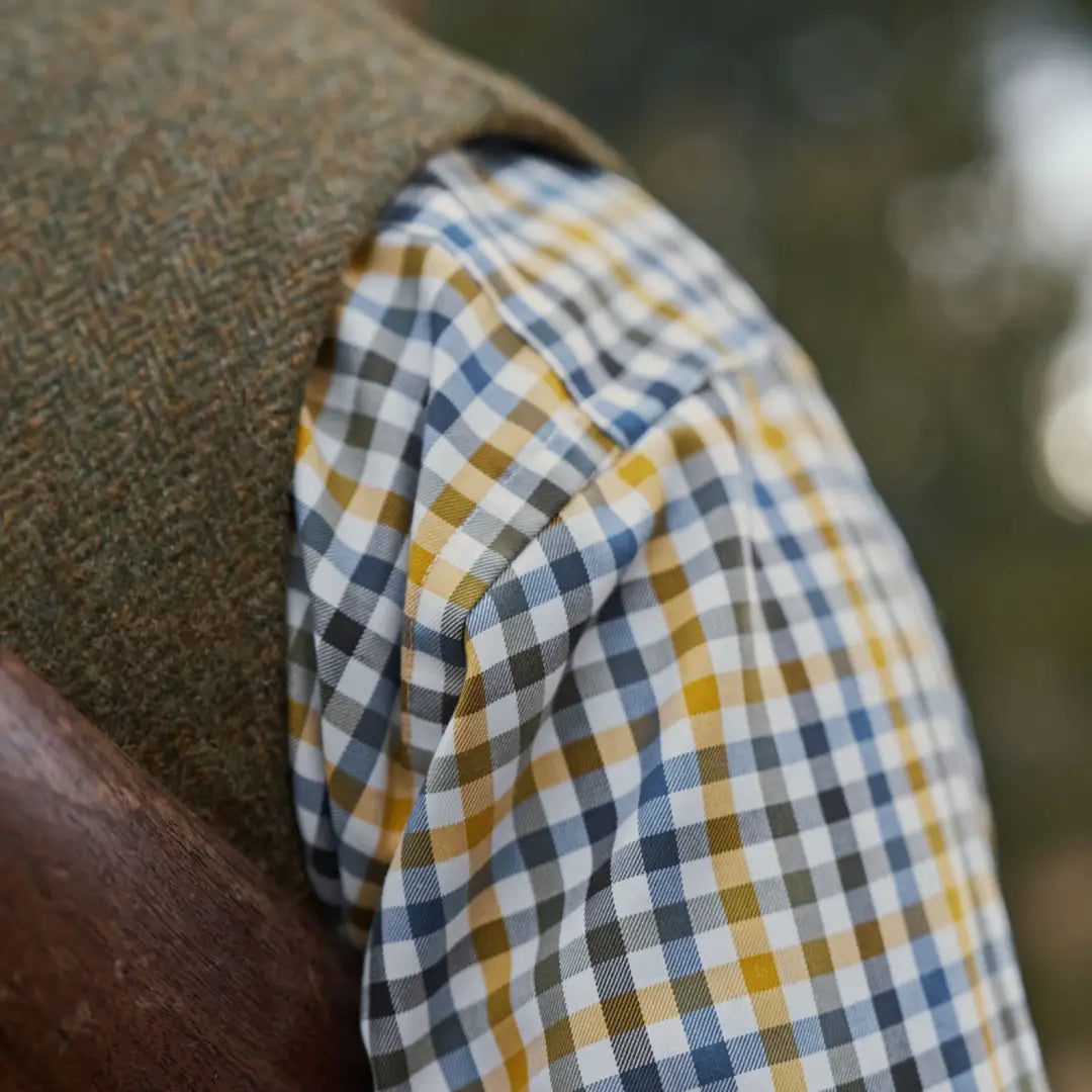 Plaid shirt sleeve and tweed vest from Härkila Milford Shirt for country hunting look