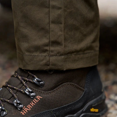 Olive green Harkila Fjell Trousers with brown hiking boots for stylish country clothing