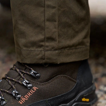 Olive green Harkila Fjell Trousers with brown hiking boots for stylish country clothing