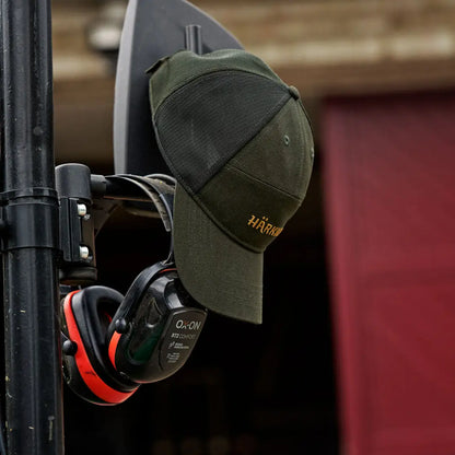 Green Harkila Impact Cap with ear protection, perfect for hunting and country clothing