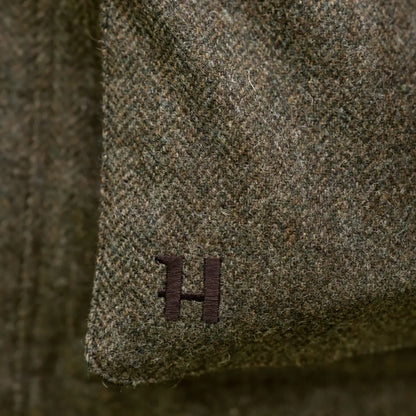 Green herringbone fabric with embroidered H on Kenmore GTX Jacket for style and durability