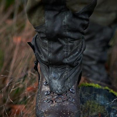 Rugged leather hiking boot with laces in outdoor setting near Harkila Pro HWS Gaiters