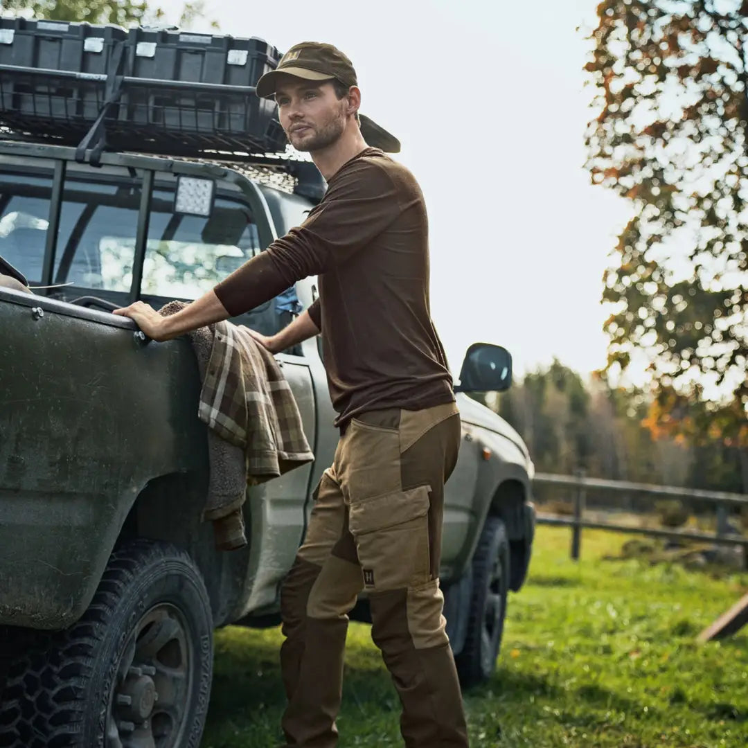 Man in hunting attire wearing Härkila Scandinavian Trousers for outdoor adventures