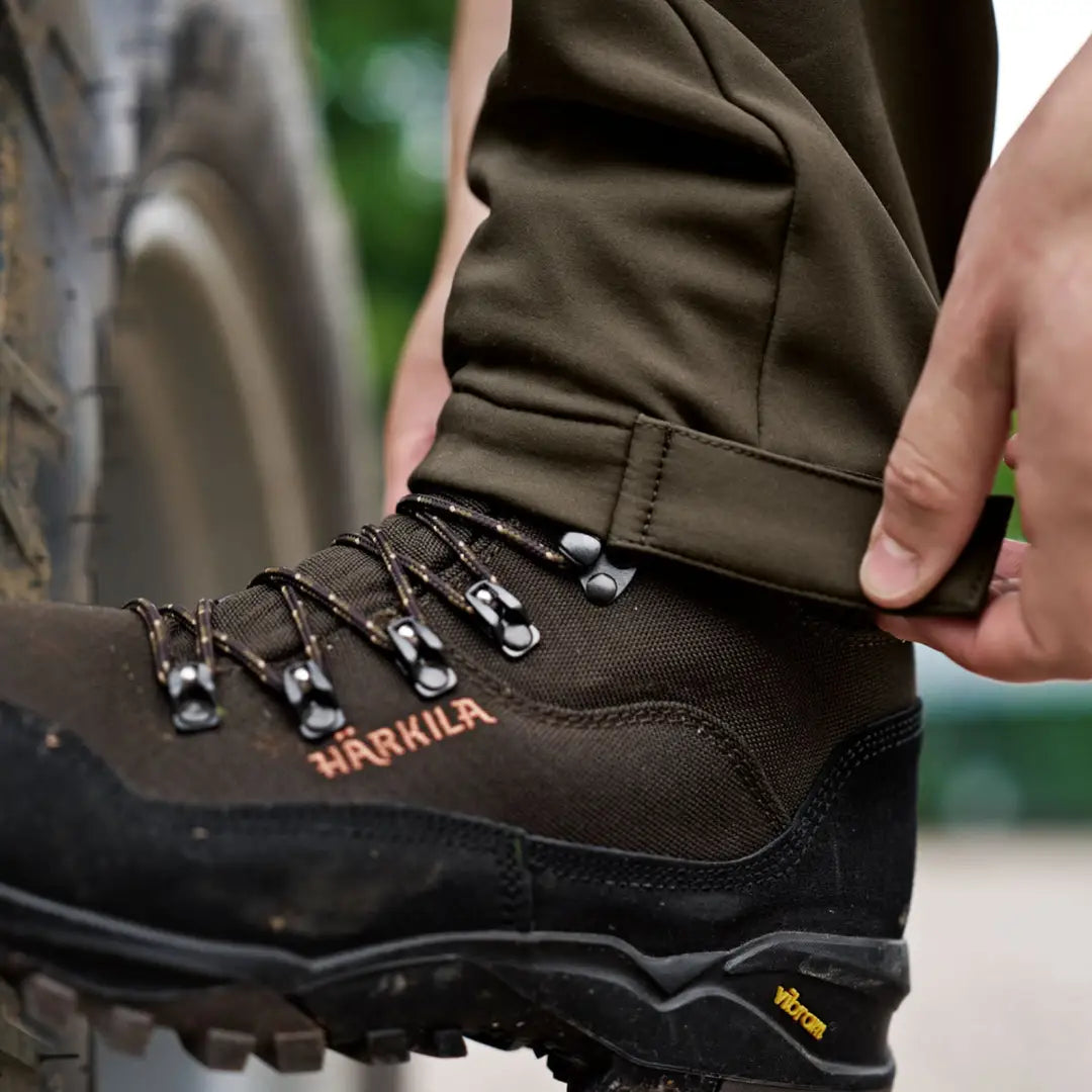 Brown hiking boot with Härkila Scandinavian Trousers for a rugged outdoor look