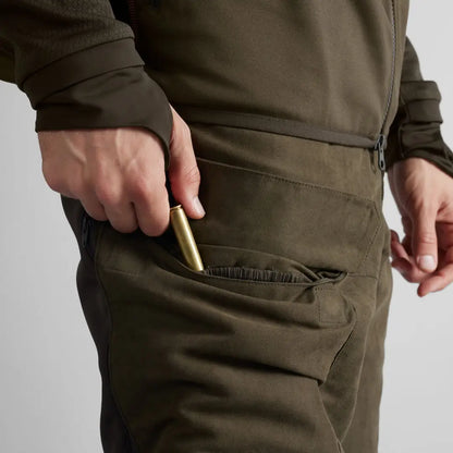 Bullet being inserted into pocket of Härkila Scandinavian Trousers for easy storage