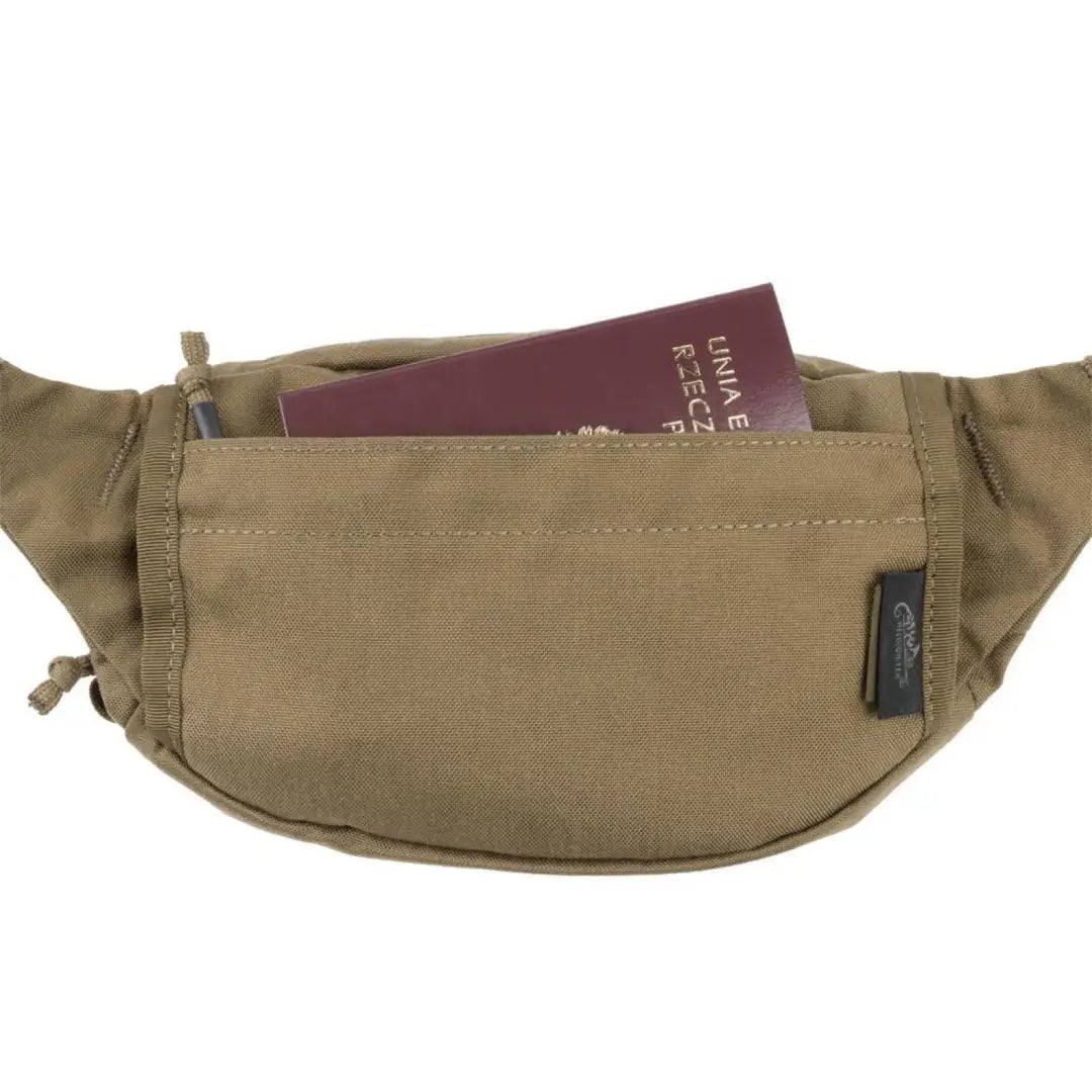 Tan Helikon-Tex Possum Cordura Waist Pack with a passport, perfect for outdoors adventures