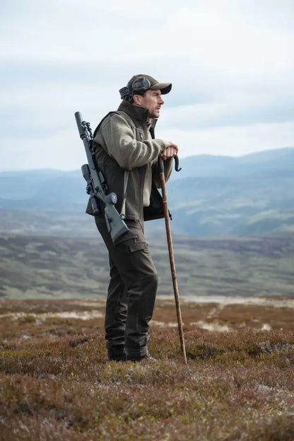 Black tactical backpack with molle webbing, perfect for Hoggs of Fife Ardross 4-Way stretch trousers