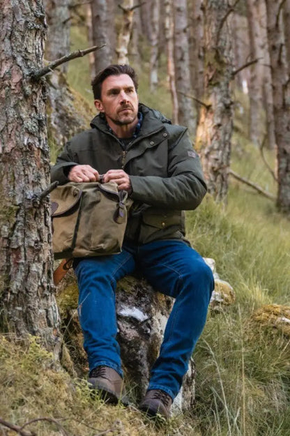 Olive green waxed canvas duffle bag with leather accents, perfect with Hoggs of Fife Clyde Comfort Denim Jeans