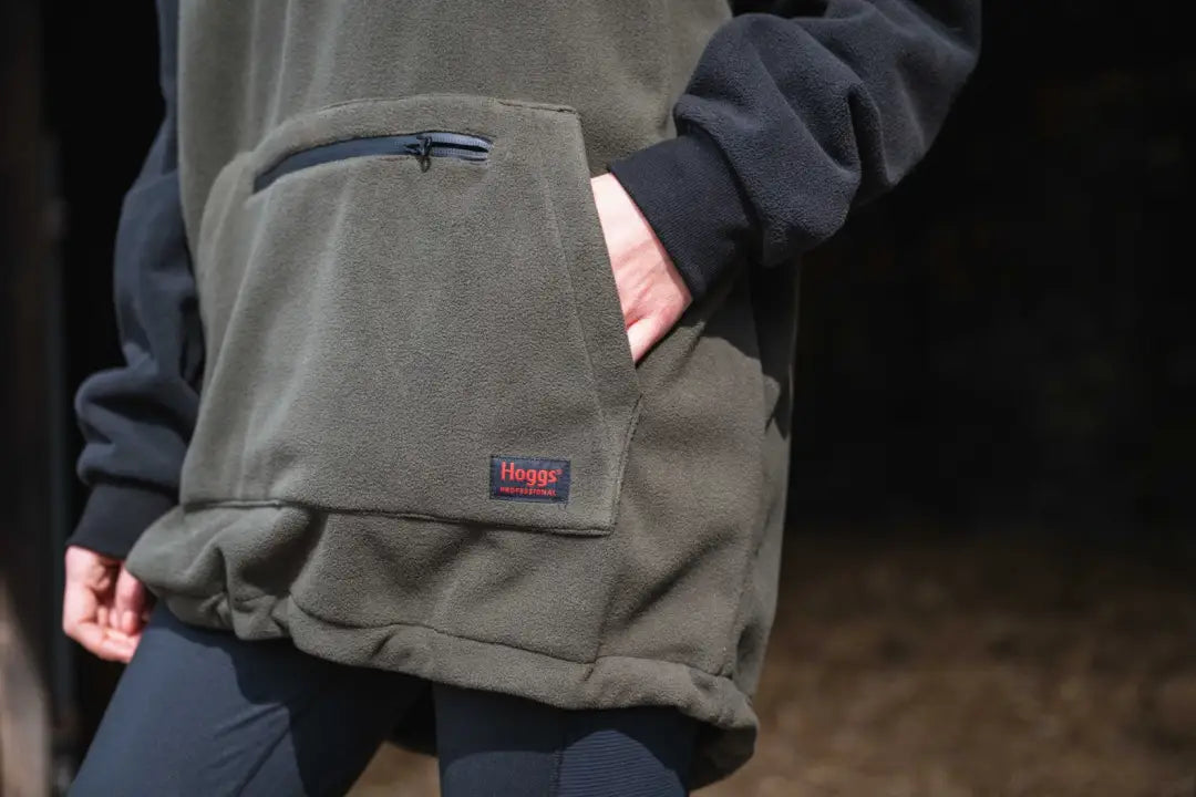 Olive green waxed canvas messenger bag with blue accents and Haglöfs logo for King II Stormproof