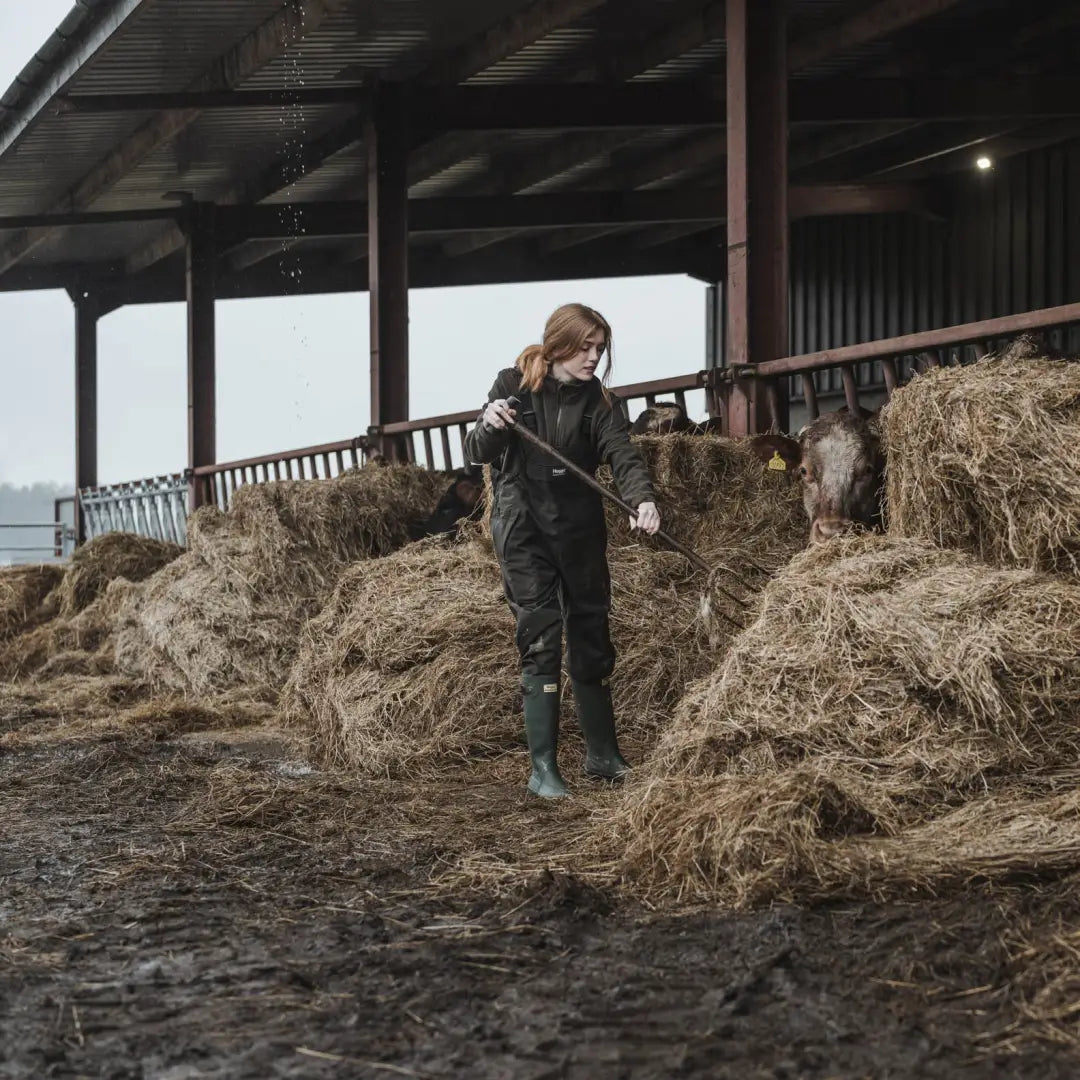 Person in Hay with Pitchfork Wearing Hoggs of Fife Green King II Waterproof Bib & Braces