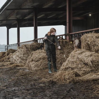 Person in Hay with Pitchfork Wearing Hoggs of Fife Green King II Waterproof Bib & Braces