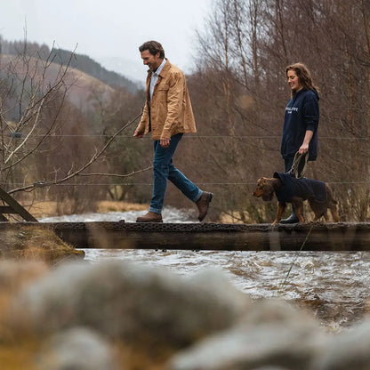 People and dog crossing a bridge in Hoggs of Fife Huntly Waxed Canvas Utility Overshirt